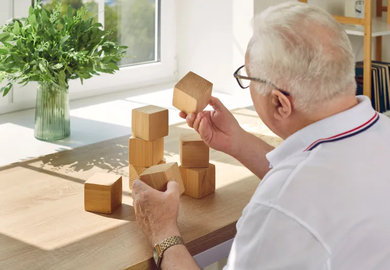 Man holding wooden block