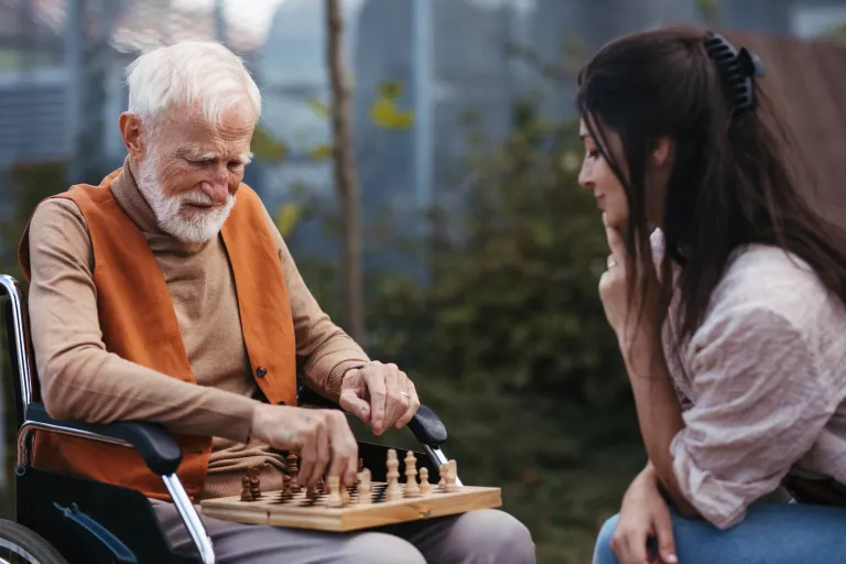 Image of staff speaking with resident